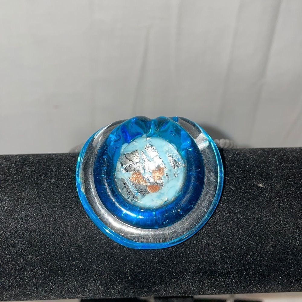 Necklace with a silky thread and a large glass emblem